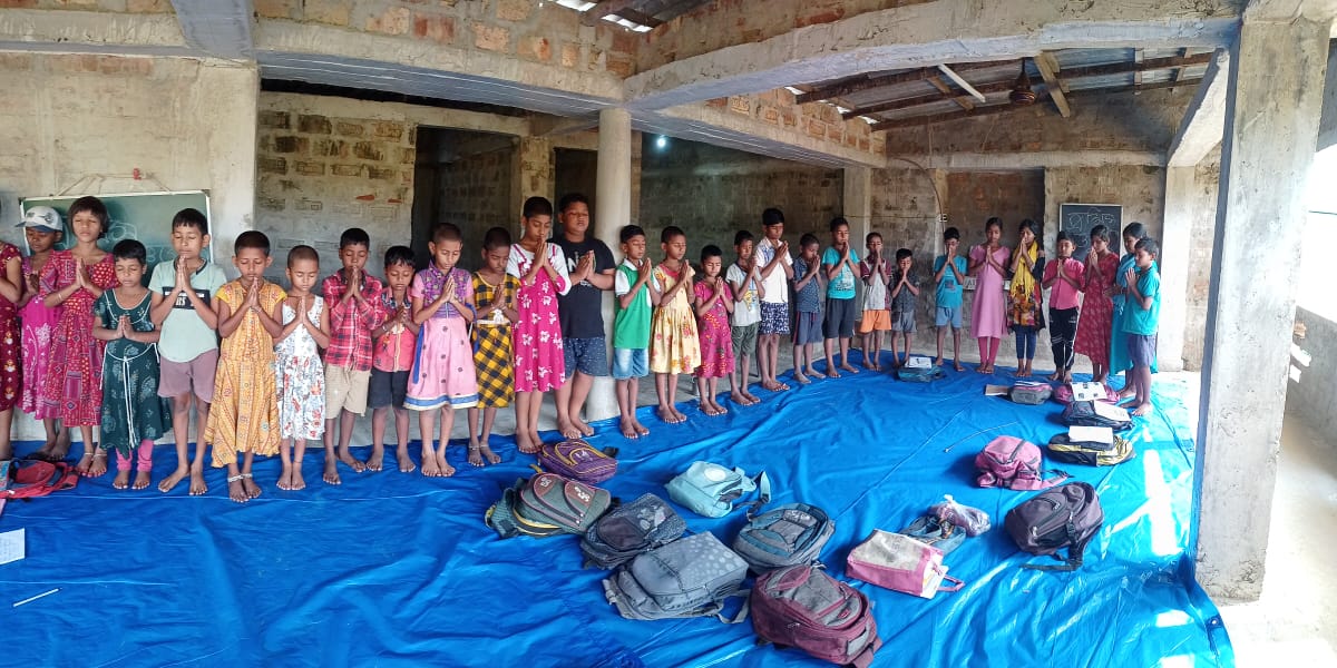 Rows of donated school bags and learning supplies for children